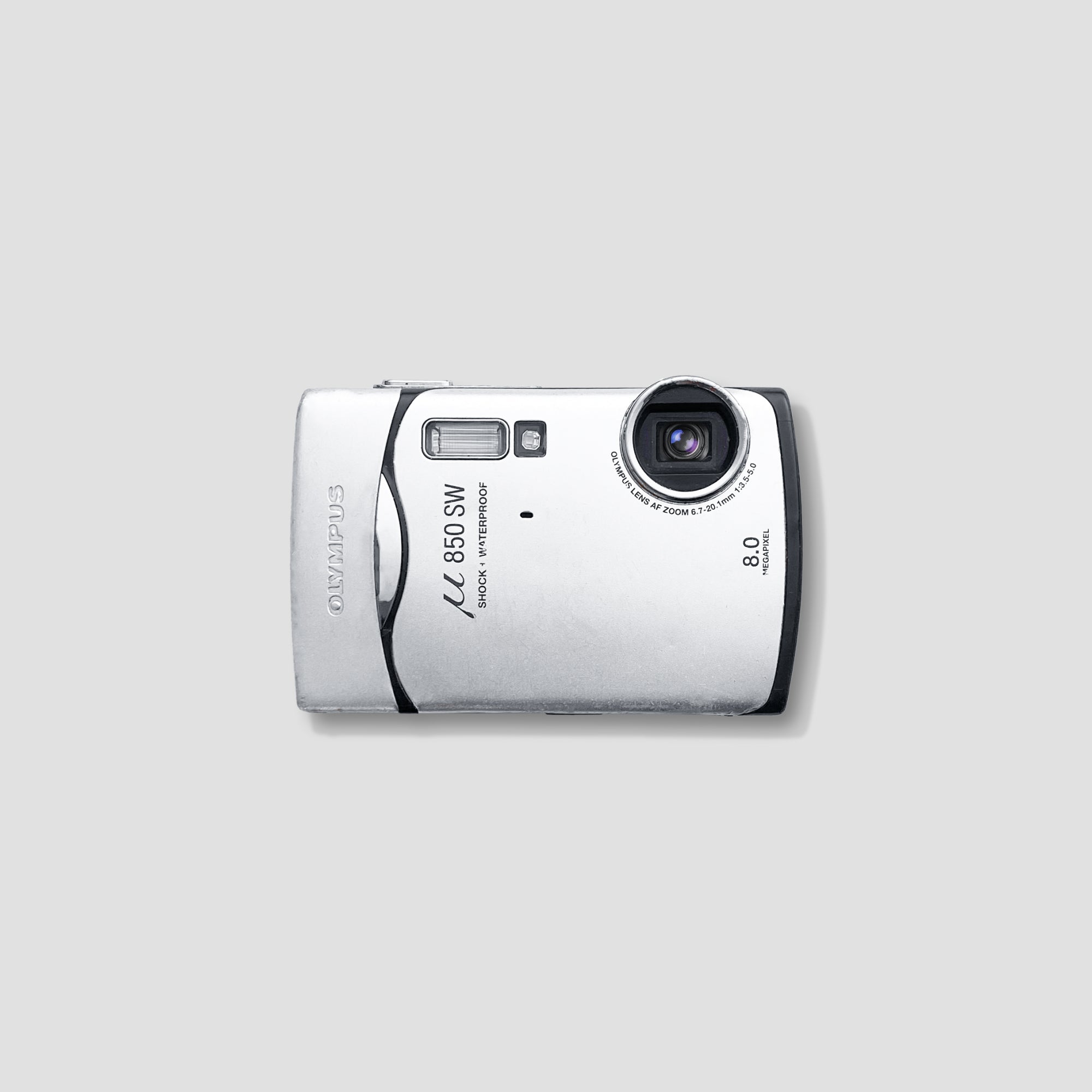 Olympus Stylus 850 SW rugged digital camera with a scenic mountain backdrop