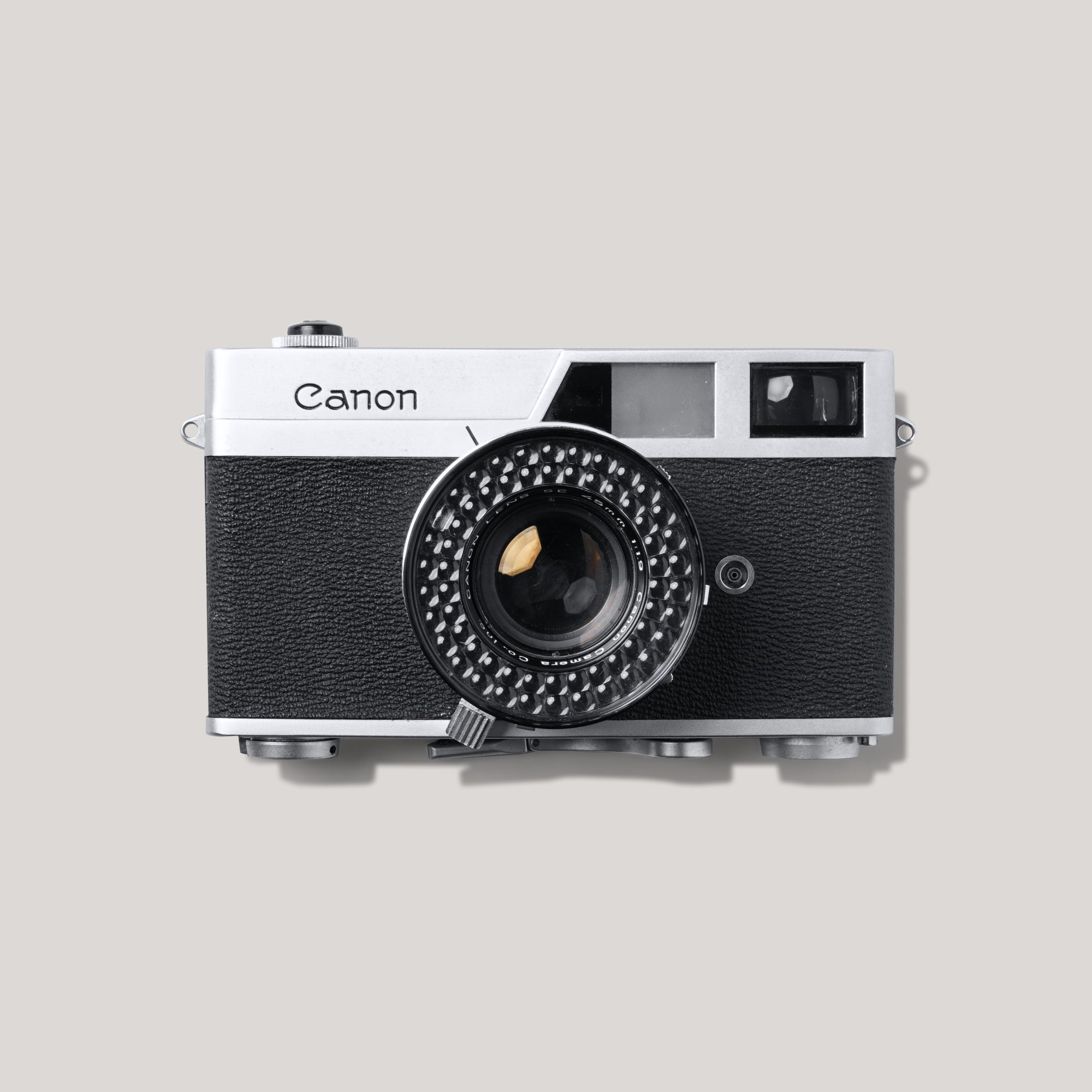 Close-up of Canonet vintage rangefinder camera highlighting its sleek body and lens.