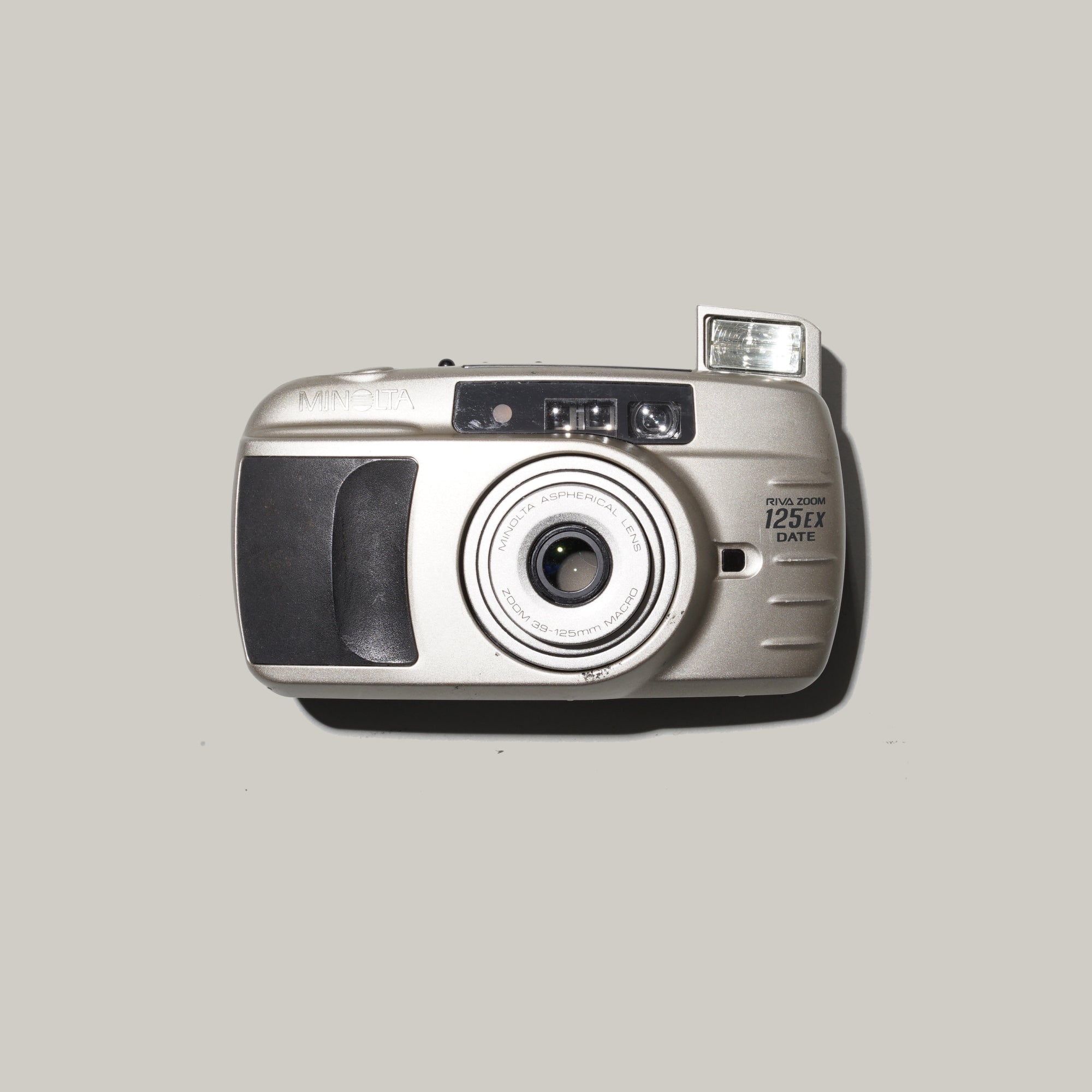 Minolta Riva Zoom 125 EX camera with zoom lens and flash in hand
