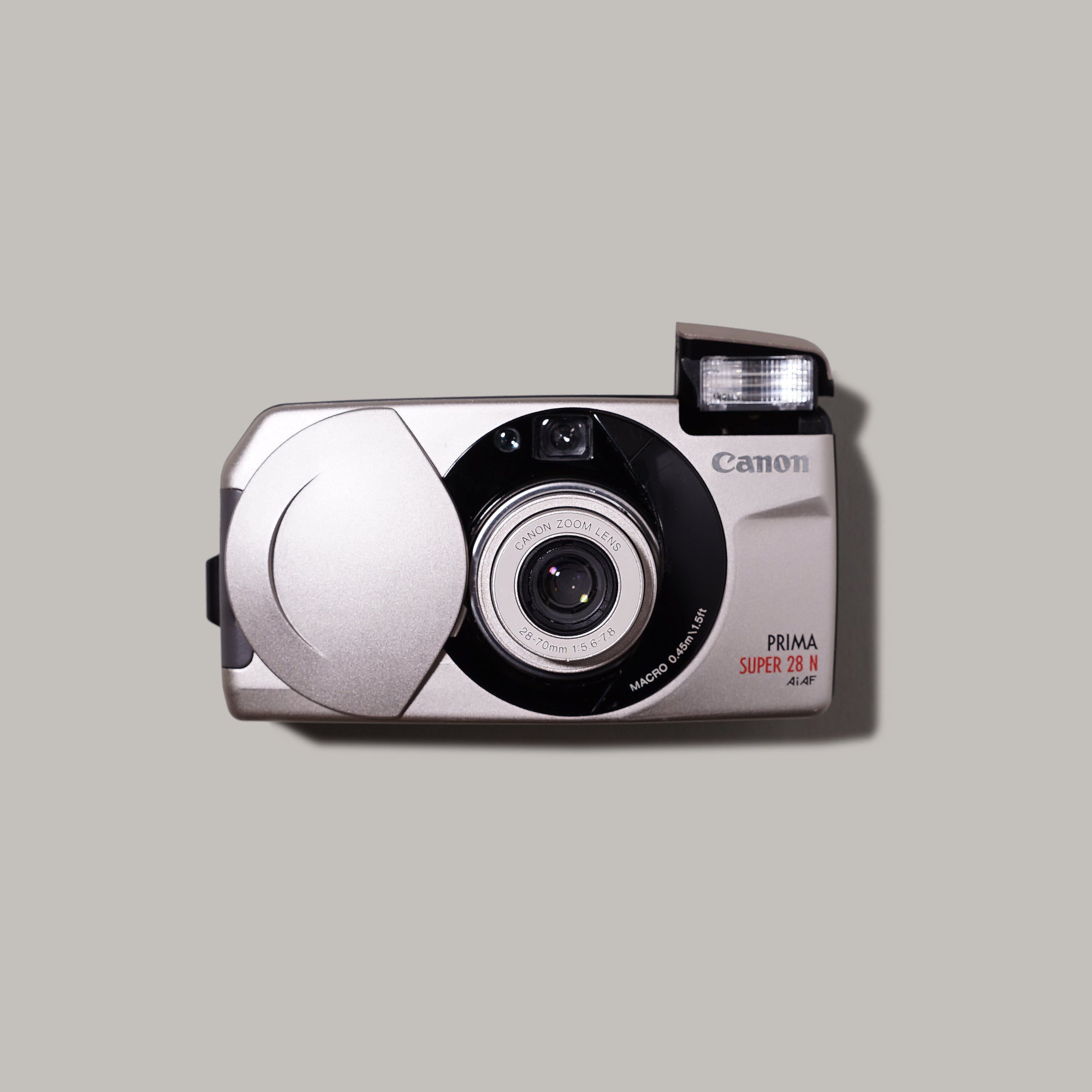 Close-up of Canon Prima Super 28N point and shoot film camera showcasing its unique clamshell design.
