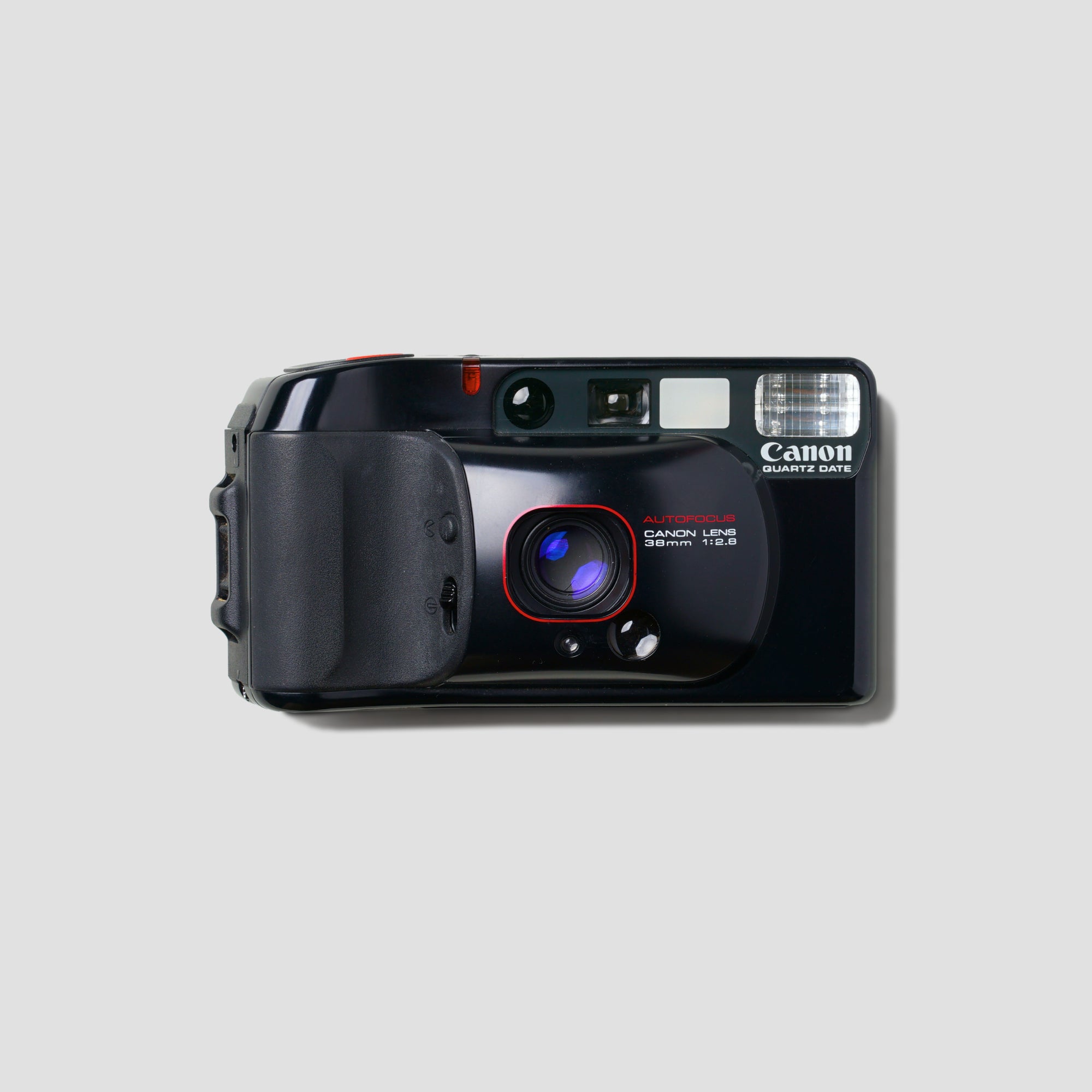 Vintage Canon Top Shot camera from a side angle, showcasing its compact design.