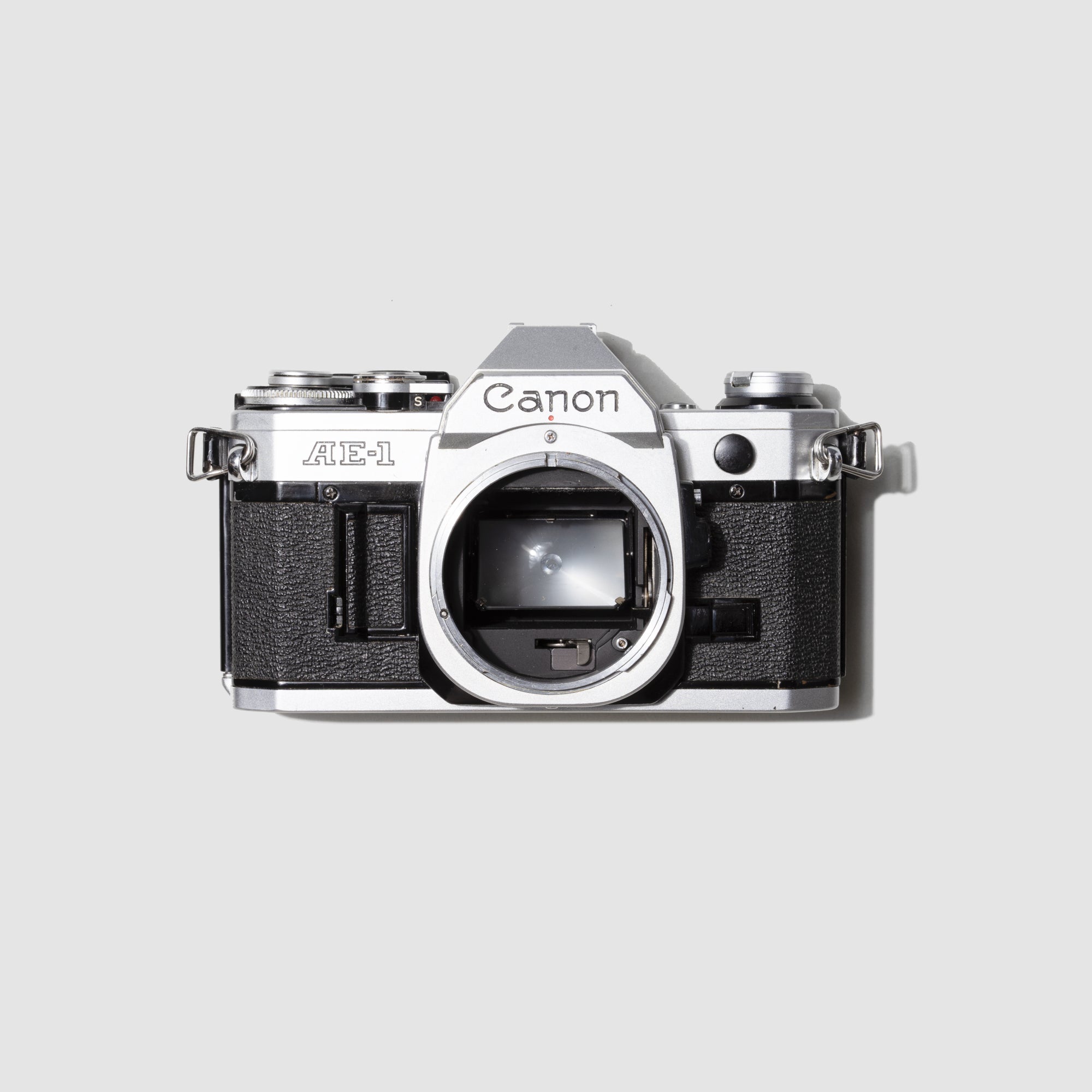 Front view of the Canon AE-1 vintage film camera highlighting its sleek design and metal body.