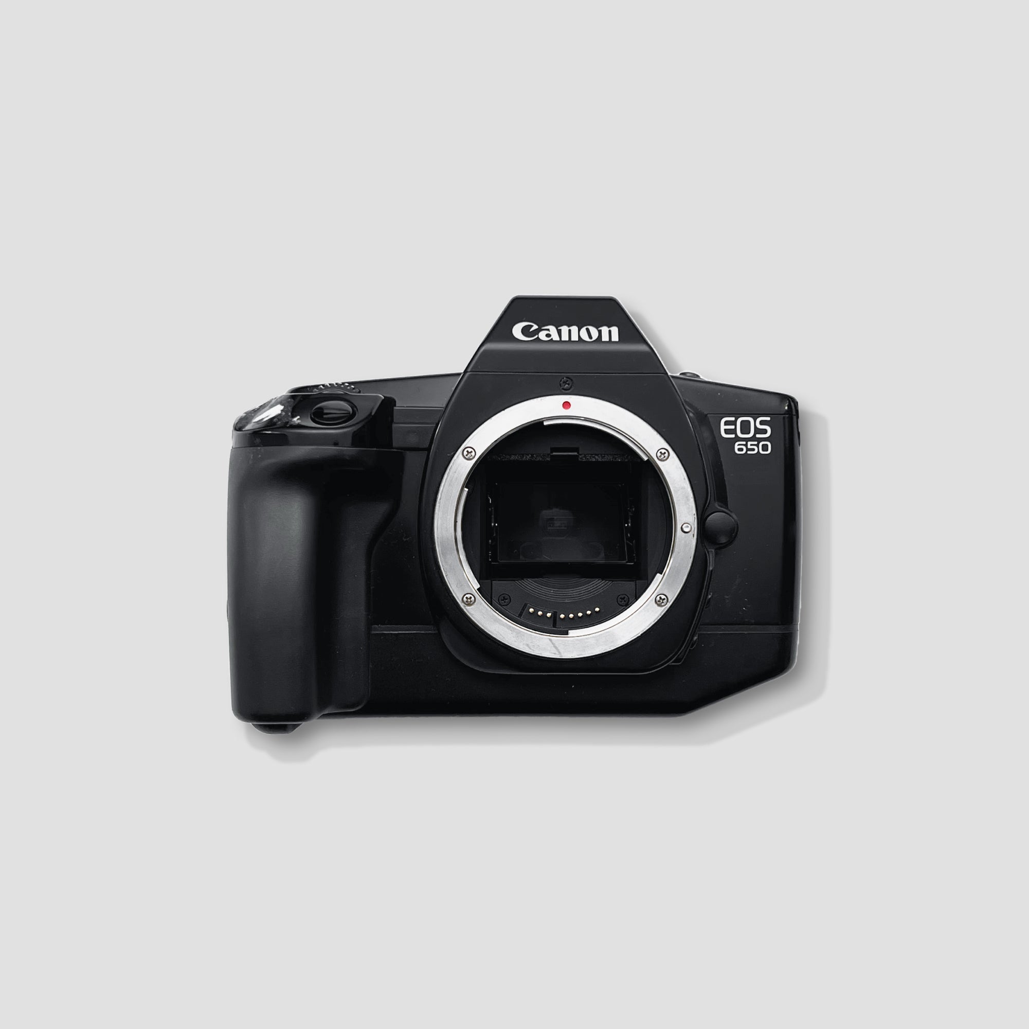Canon EOS 650 film camera showcasing its sleek design and lens compatibility.