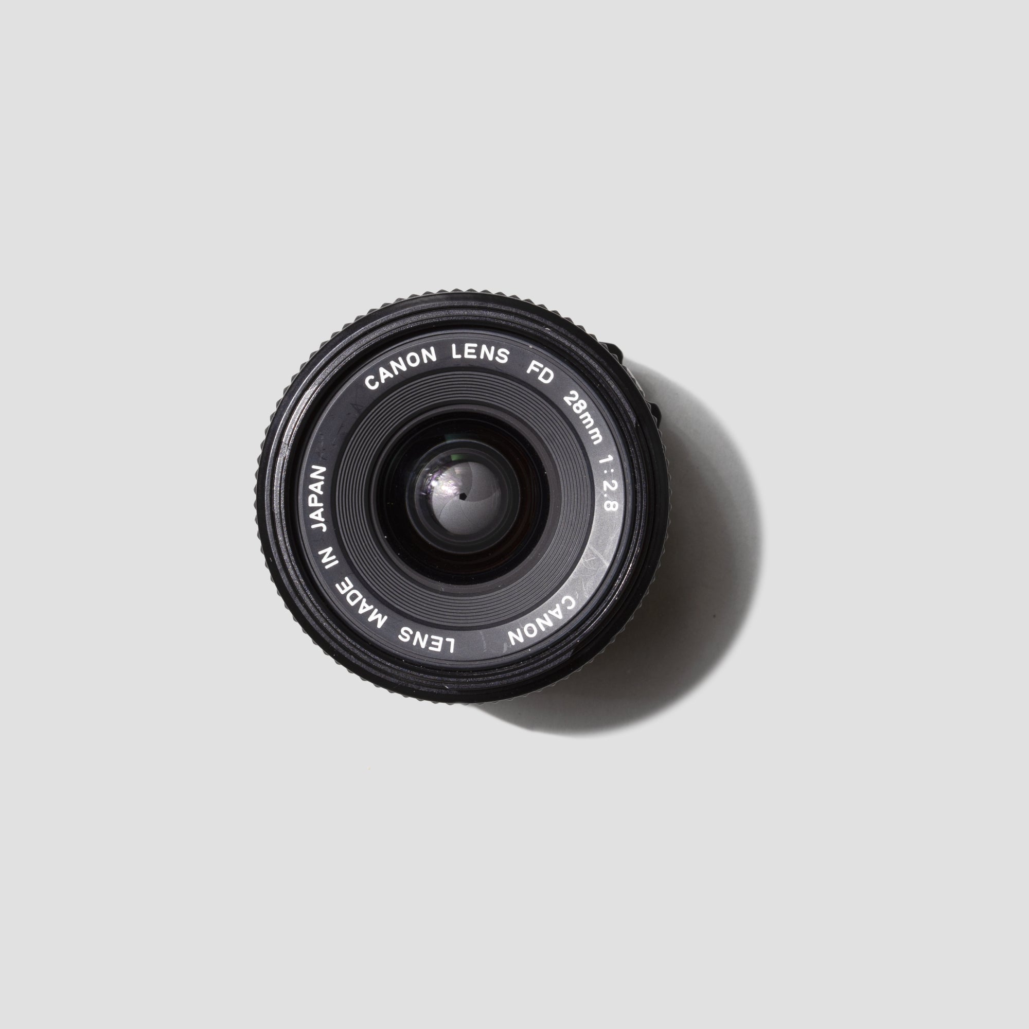 Wide-angle view of the Canon FD 28mm f/2.8 lens showcasing its sleek design and mount compatibility.
