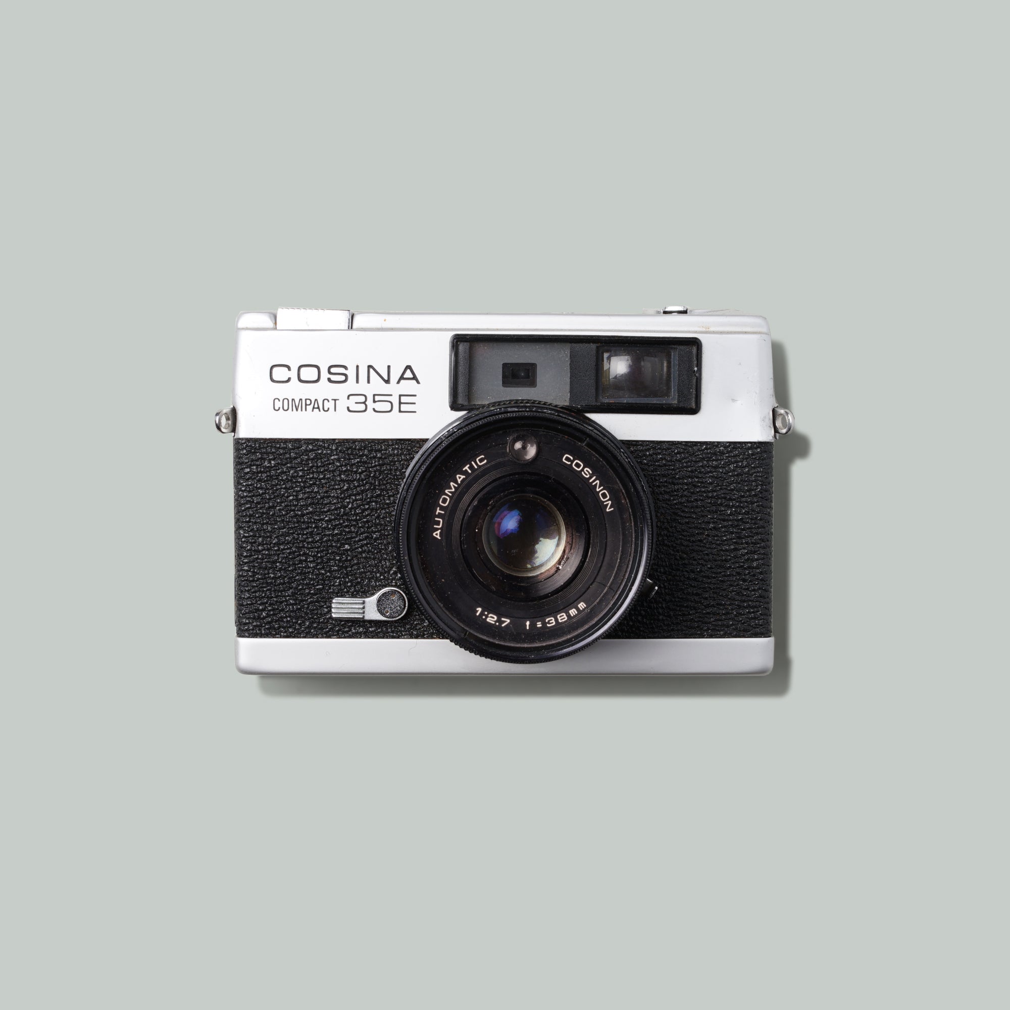 Close-up of the Cosina Compact 35E with manual focus dial and light meter