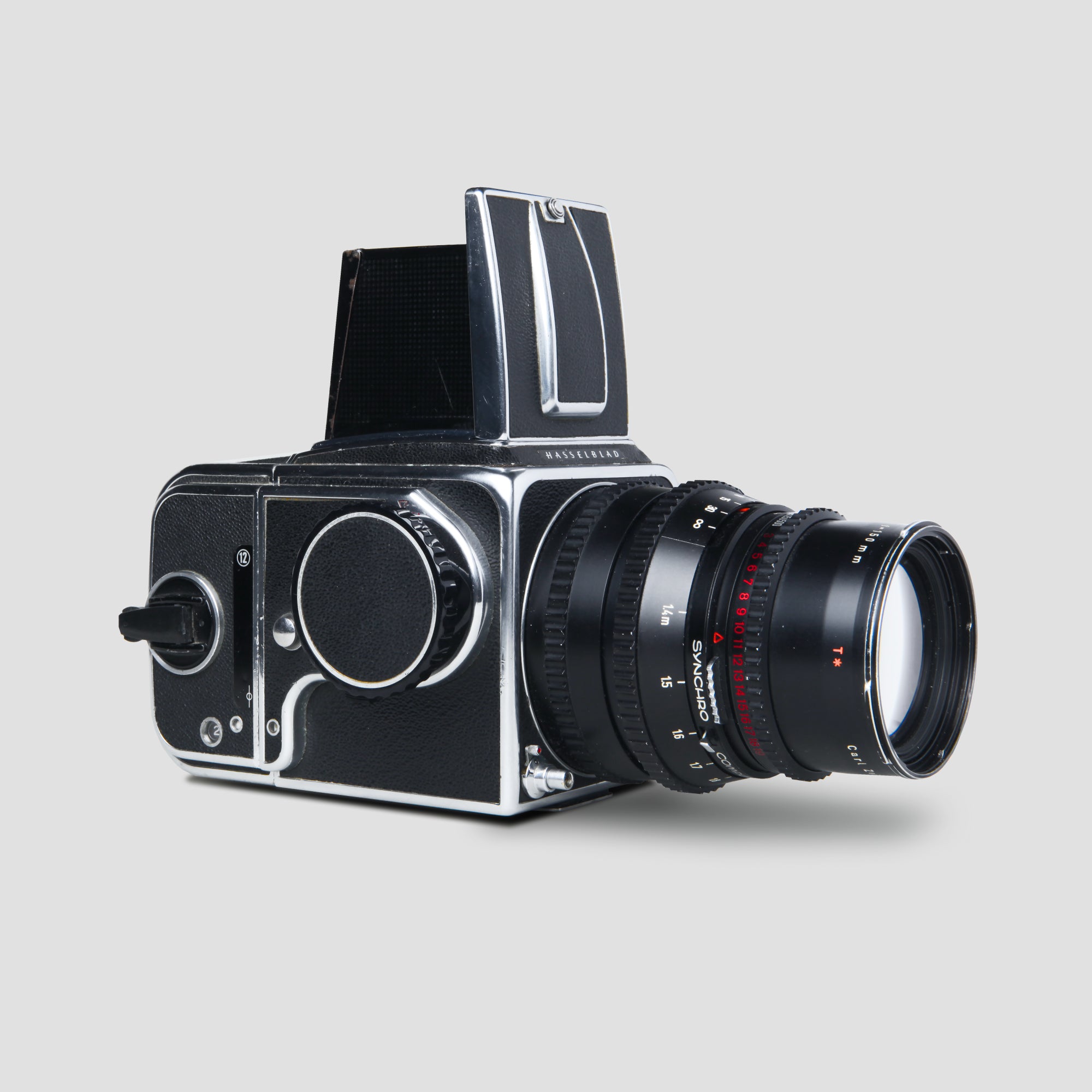 Hasselblad 500C vintage camera with Sonnar 150mm lens on a wooden table, highlighting its classic design and craftsmanship.
