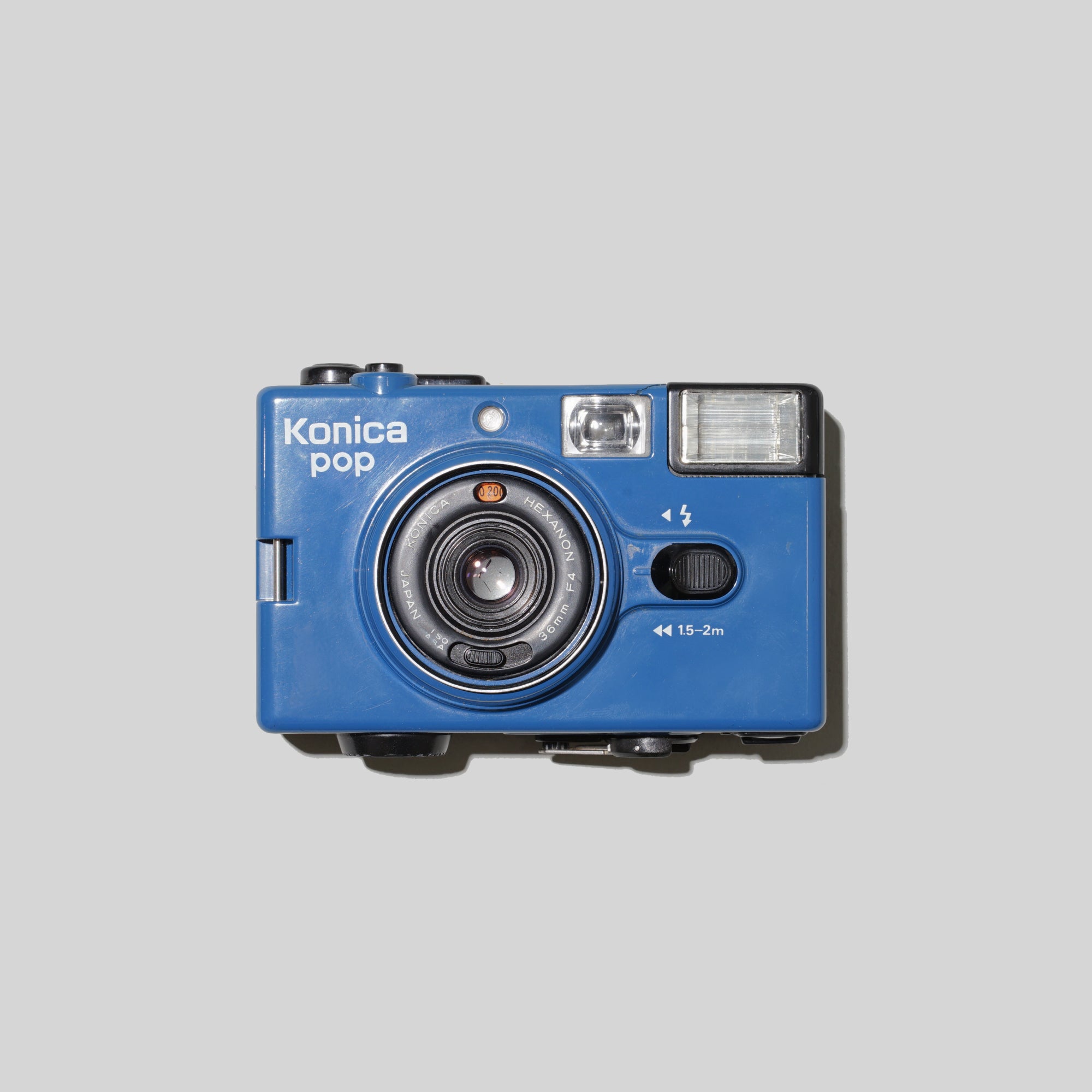 Front view of the Vintage Konica Pop Blue 35mm film camera highlighting its vibrant color and compact size.