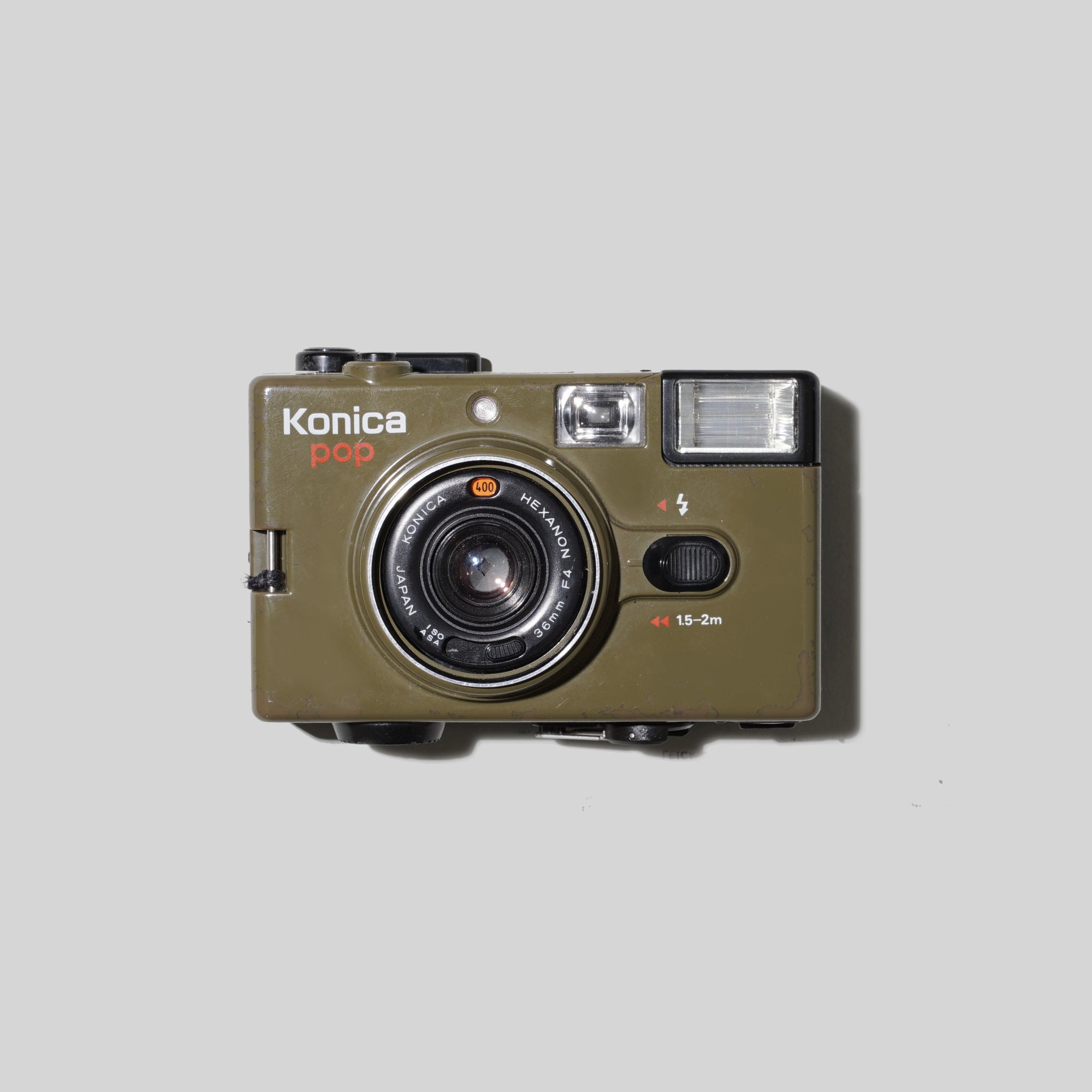 Front view of the Konica Pop Olive Green vintage 35mm film camera highlighting its compact size and retro style
