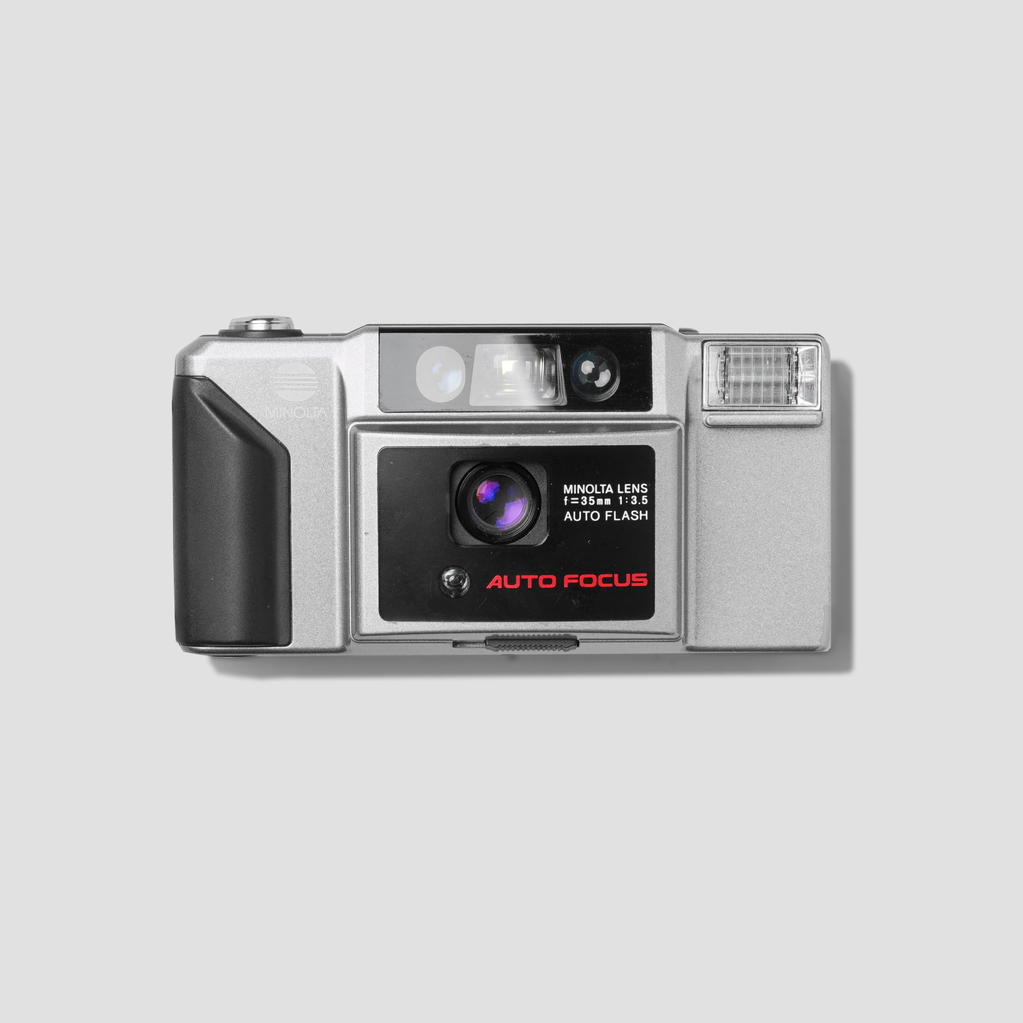 Close-up view of the Minolta AF-E Silver camera displaying its sleek silver finish.