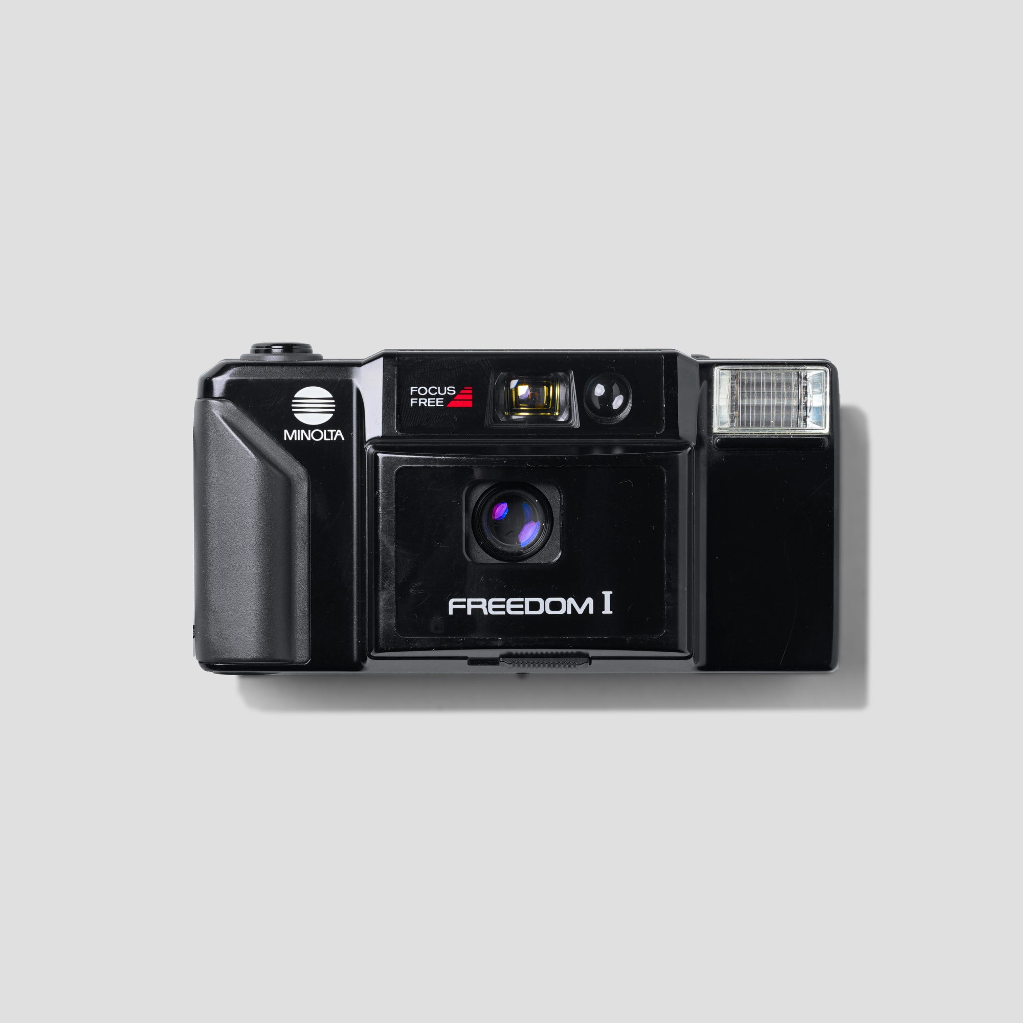 Front view of the Minolta Freedom I camera showcasing its sleek design, perfect for travel photography.