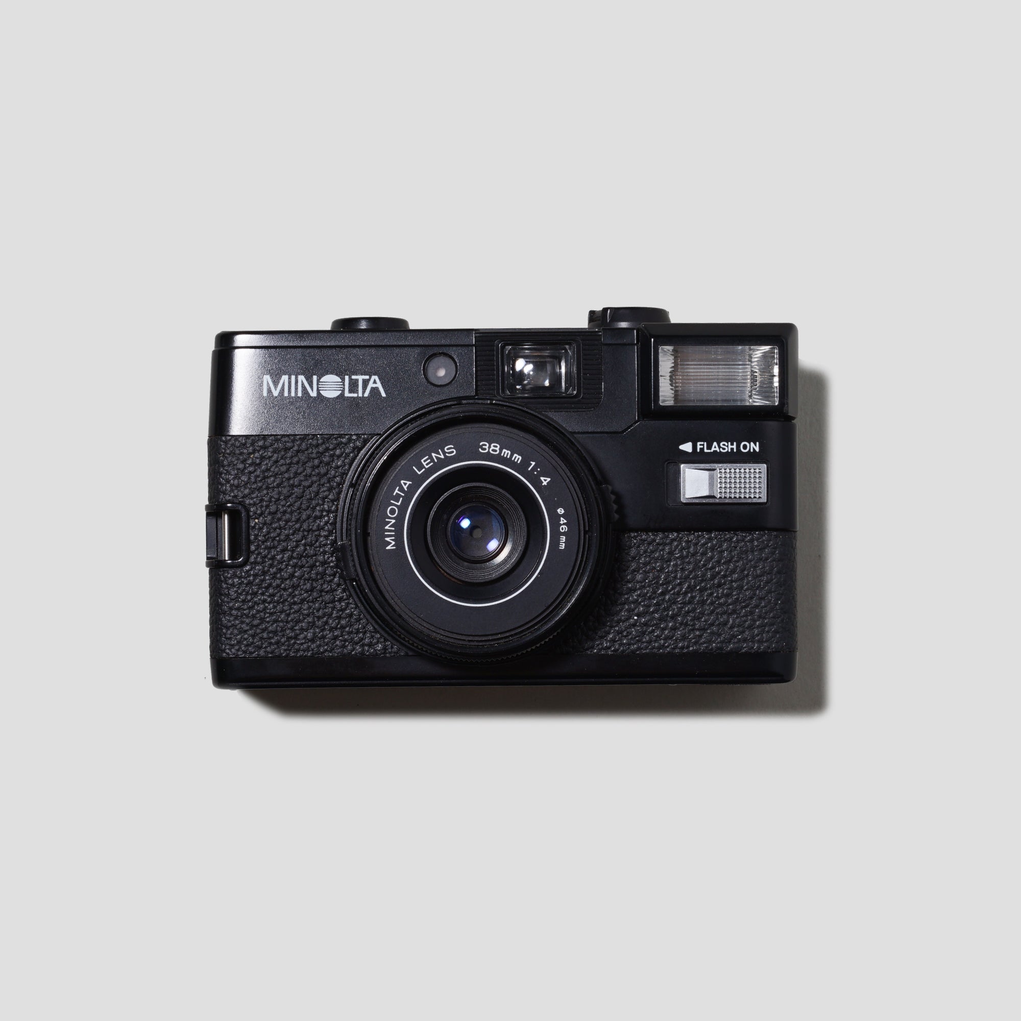 Front view of the Minolta Hi-Matic GF compact film camera showing its sleek design.
