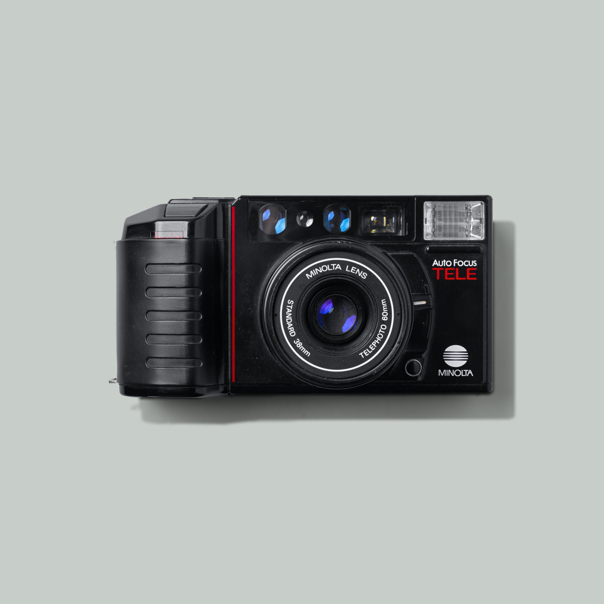 Front view of Minolta AF-Tele compact film camera with switchable lenses