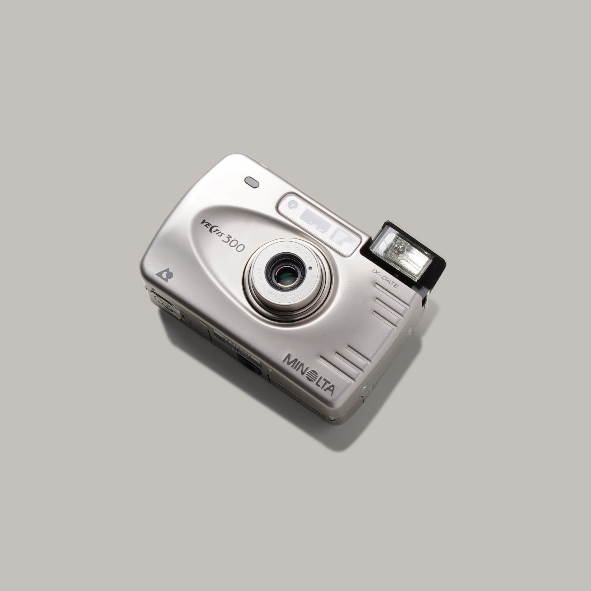 Minolta Vectis 300 film camera showcasing its sleek design and 24-70mm lens.