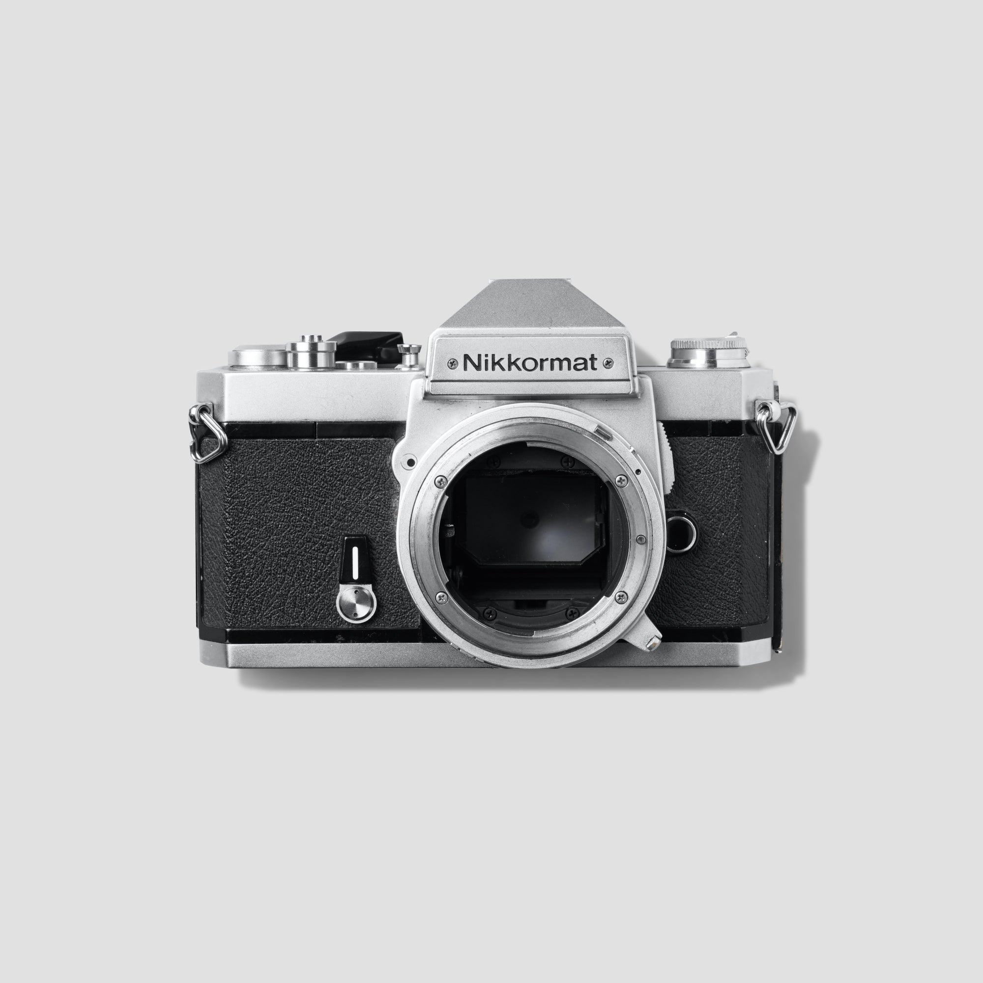 Front view of Nikon Nikkormat FT3 vintage film camera with lens attached