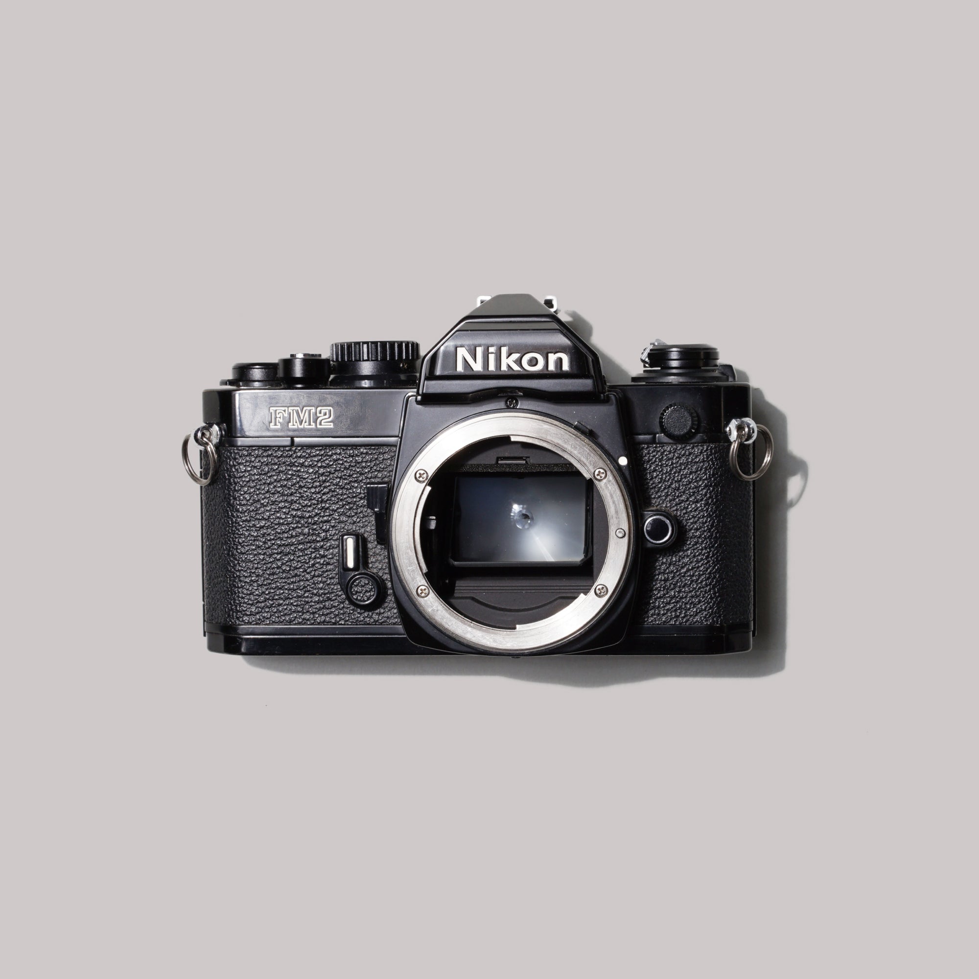 Nikon FM2n film camera showcasing its sleek design and rugged build, ideal for street photography.