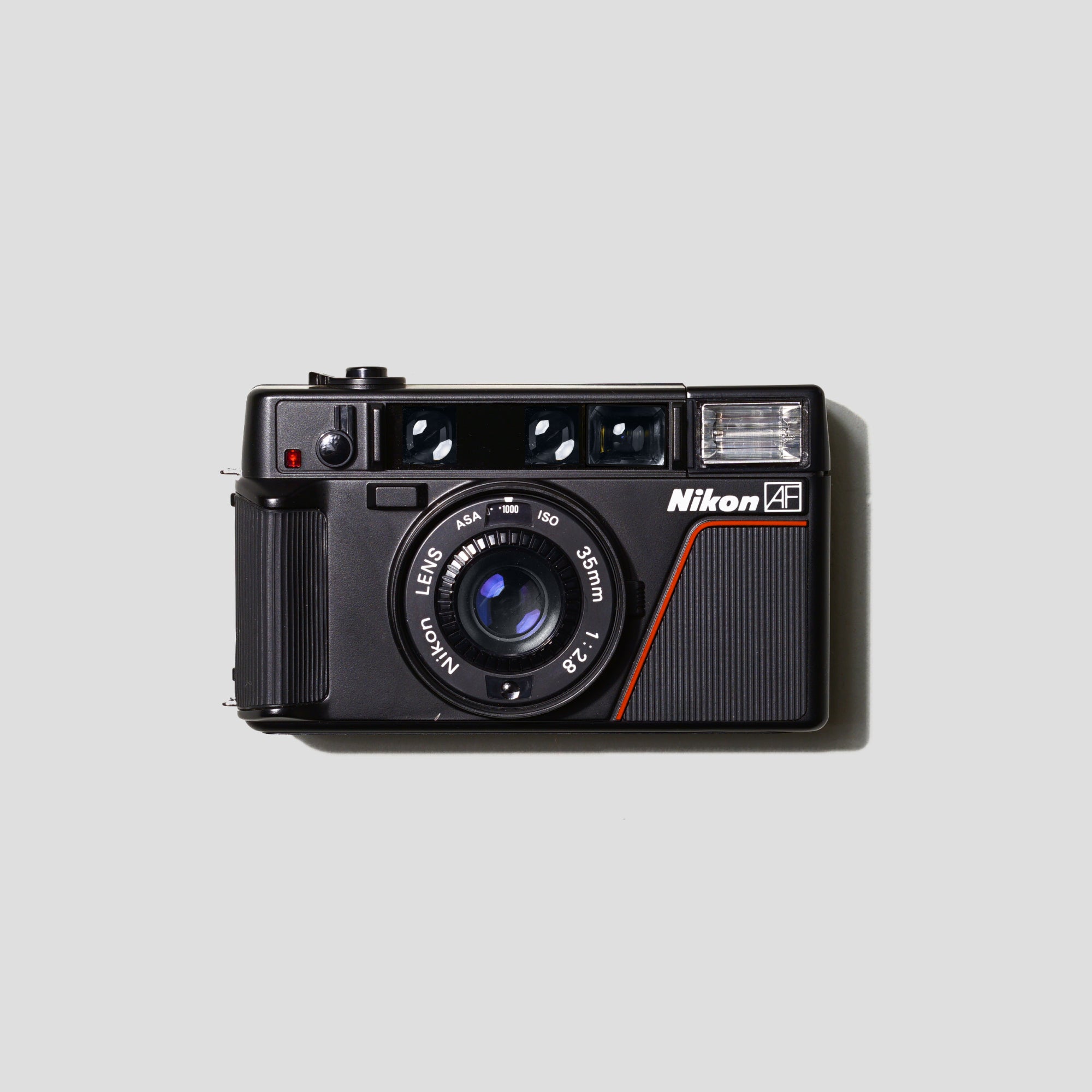 Nikon L35AF camera front view showcasing its sleek design and lens.
