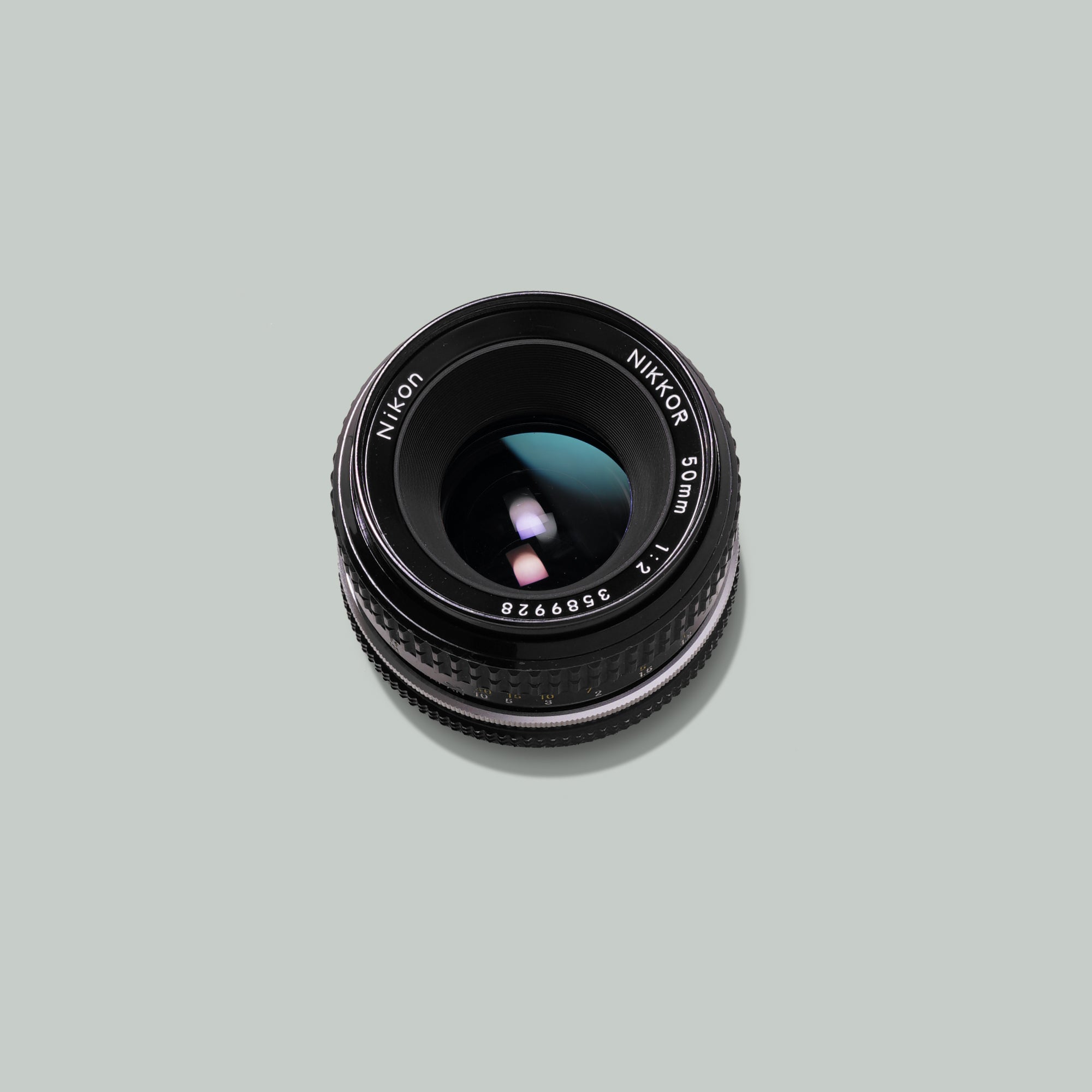 Close-up of Nikon Nikkor 50mm f/2 lens showing focus ring and aperture settings.