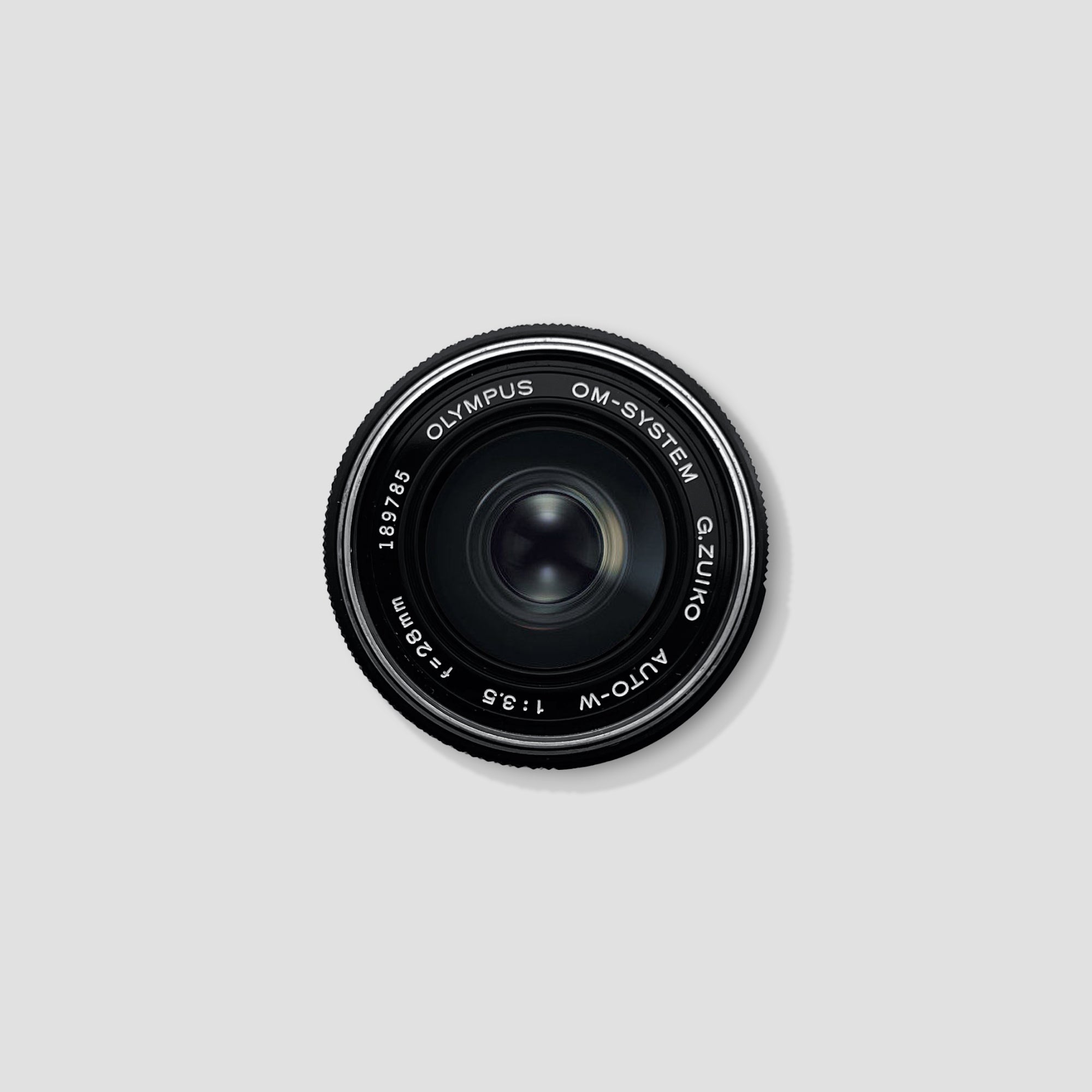 Olympus OM-System 28mm F3.5 lens close-up shot on a camera body