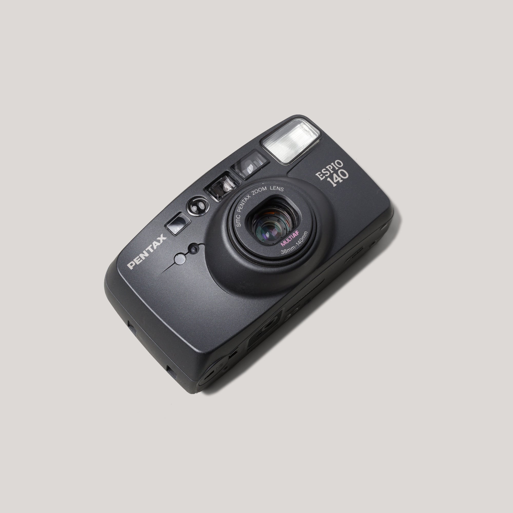 Pentax Espio 140 film camera front view with lens extended, perfect for capturing moments on 35mm film.