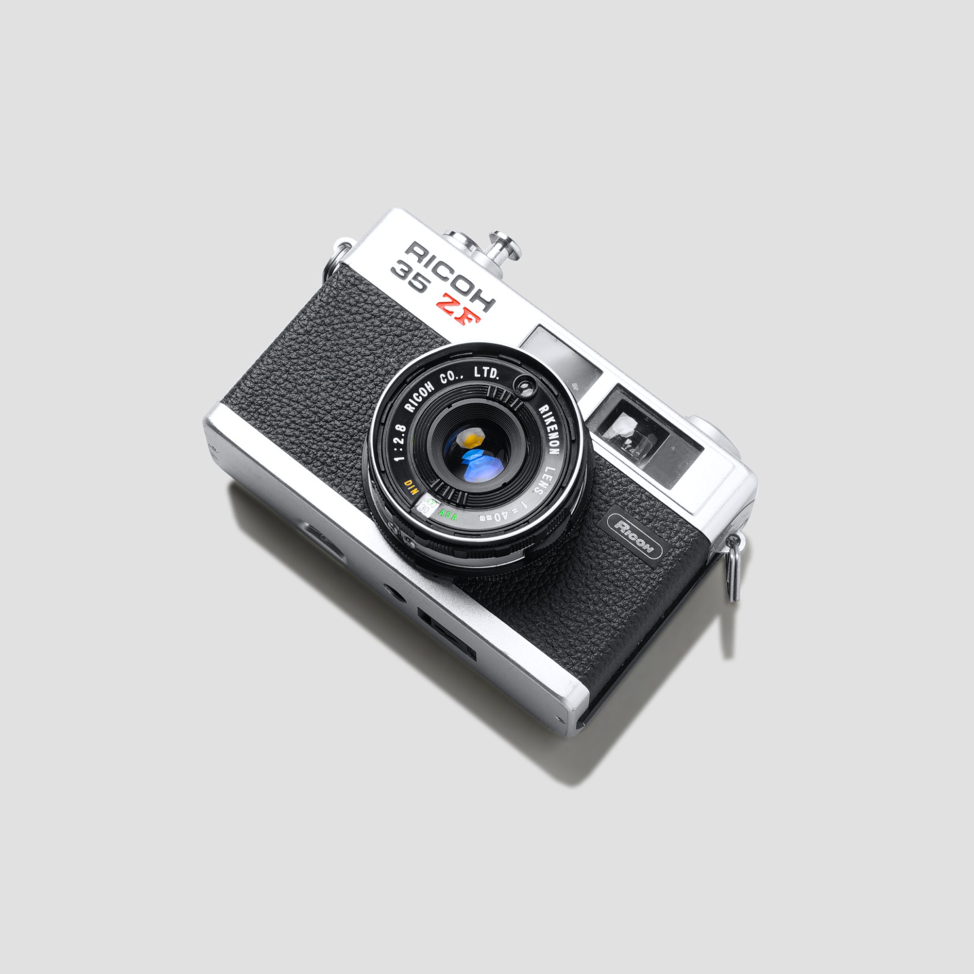 Close-up of Ricoh 35 ZF camera showing the lens and viewfinder for street photography