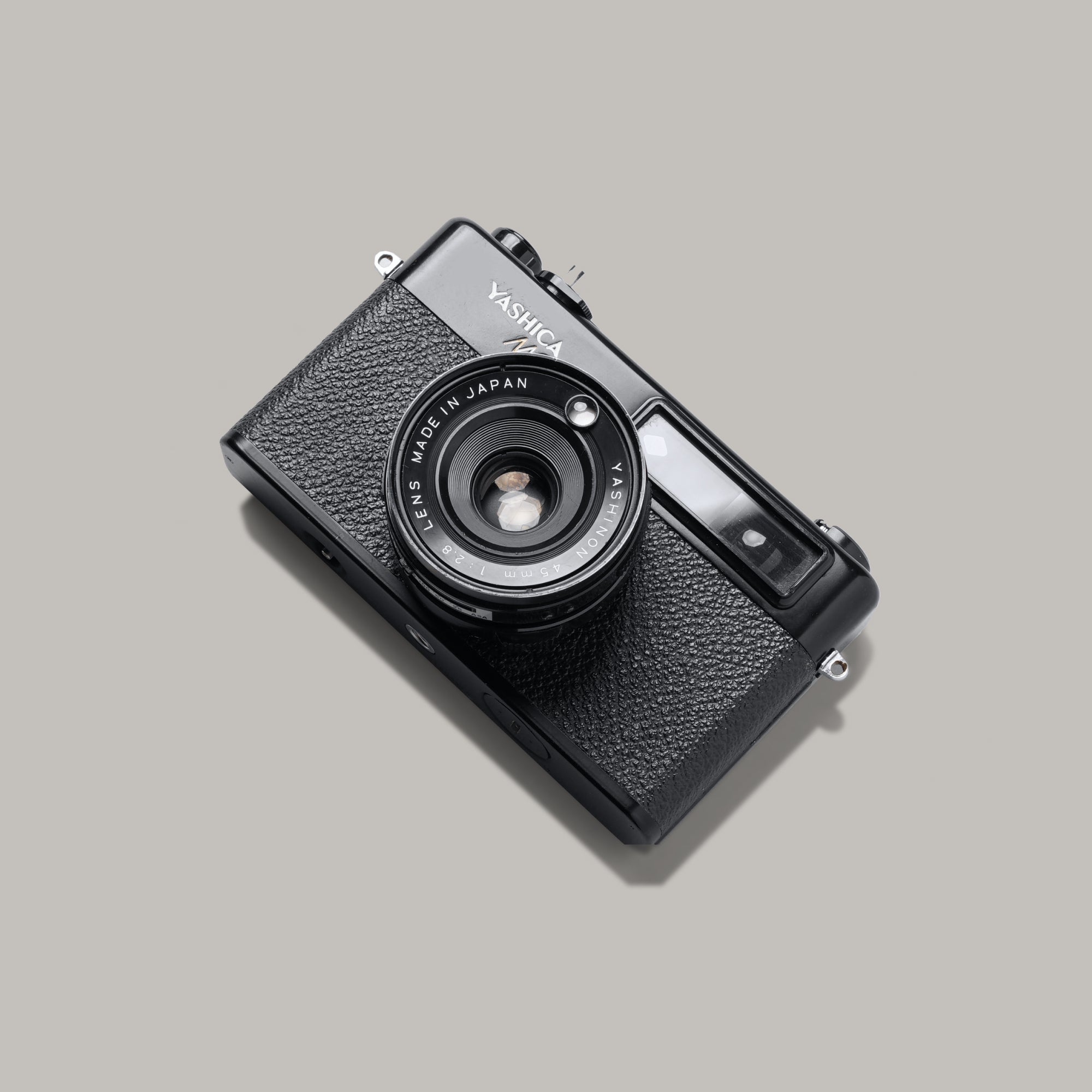 Front view of Yashica MG-1 rangefinder camera showing chrome body and Yashinon lens
